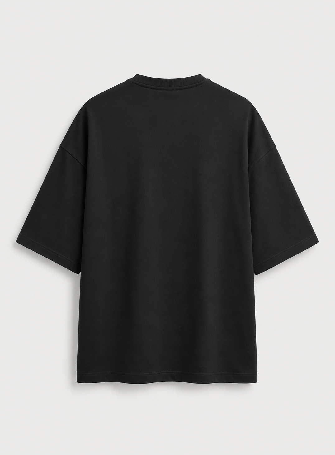A black  t-shirt shown from the back, photographed flat against a light gray background.