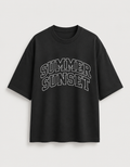 A black  t-shirt with 'SUMMER SUNSET' printed in white arched block letters across the chest, displayed on a light gray background.